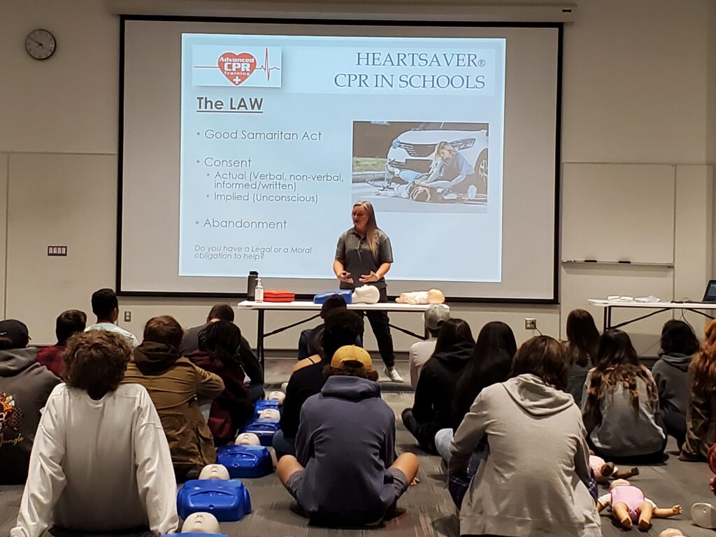 Kids in high school learning CPR